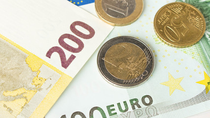 Several Euro coins on the background of Euro banknotes. The concept of savings .