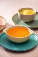 Carrot baby puree in bowl isolated on light background