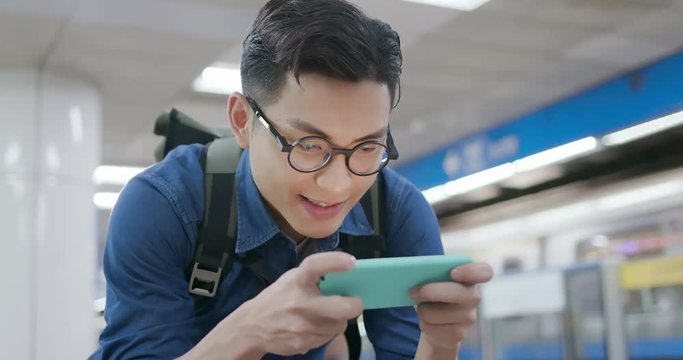 man play games with phone