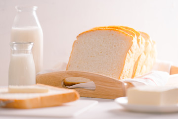 Sliced bread bake and butter on wooden tray. Simple breakfast