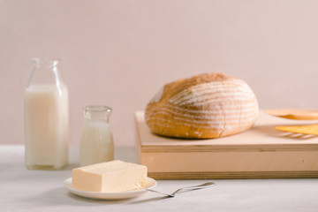 Bread bake and butter on wooden cutting board. Simple breakfast