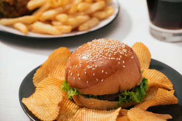 Fast food hamburger with set fried crispy chicken and french fries, ice cola on the side