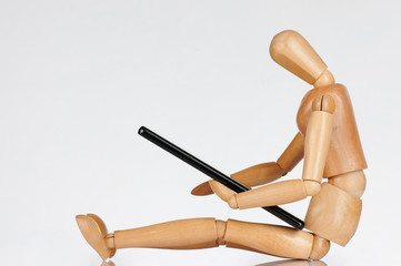 Wooden man looking on smartphone
