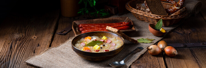 rustic sauerkraut soup with bacon and sausage