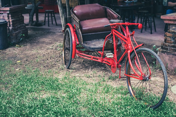 Fototapeta na wymiar The old three wheeled bicycle red.