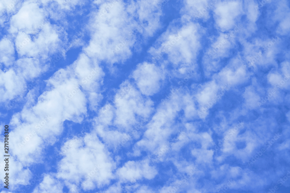 Wall mural Beautiful white fluffy clouds with blue sky background. Nature weather, the vast cloud blue sky.