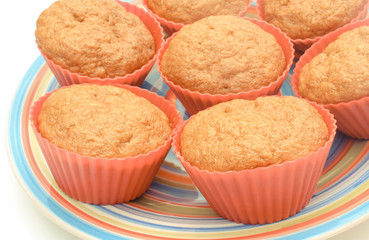 Fresh baked carrot muffins in red silicone cups. Delicious dessert