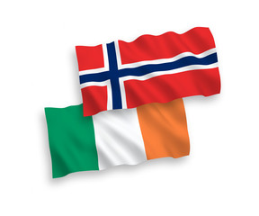 National vector fabric wave flags of Norway and Ireland isolated on white background. 1 to 2 proportion.