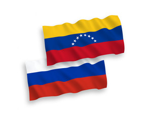 National vector fabric wave flags of Venezuela and Russia isolated on white background. 1 to 2 proportion.
