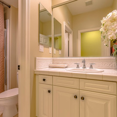 Square Interior of a small bathroom with a single sink vanity area and toilet