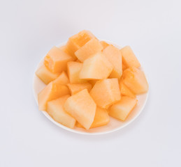 cantaloupe malons slices on white plate 