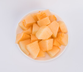 cantaloupe malons slices on white plate 