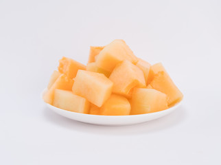 cantaloupe malons slices on white plate 