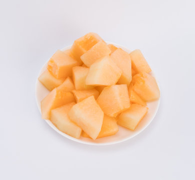 cantaloupe malons slices on white plate 