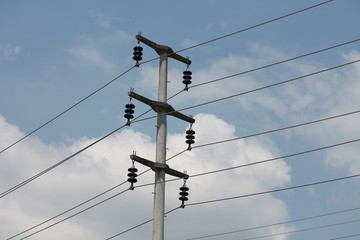 Power line support. Electric wires on a blue sky background. High-voltage lines in the modern city.