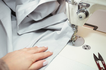 Sewing bed linen.seamstress hands