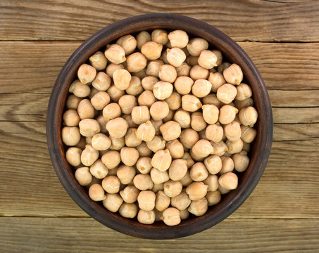 chickpeas in bowl  on old wooden background.