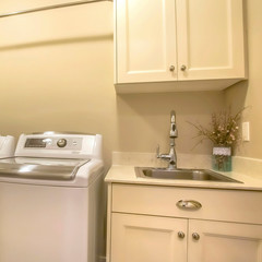 Frame Square Washing machine and dryer inside the laundry room of a house