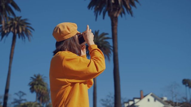 Young girl taking photo in Los Angeles