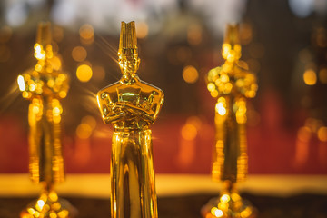 Multiple Golden chef trophy use in cooking competition close up.