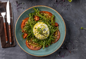 burrata cheese with pesto and arugula