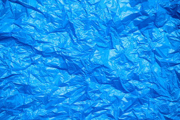Blue crumpled plastic bag texture background. Waste recycle concept. Polyethylene clear garbage bags. 