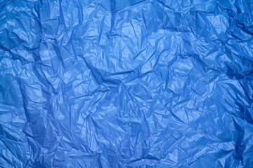 Fototapeta premium Blue crumpled plastic bag texture background. Waste recycle concept. Polyethylene clear garbage bags. 