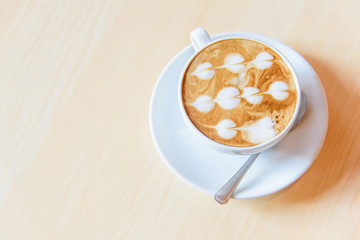 Obraz na płótnie Canvas hot coffee on table / hot cappuccino with nice pattern milk foam 