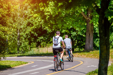 Cyclists ride on the bike path in the city Park 