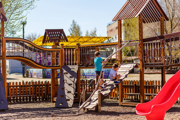 preschool children play on the wooden Playground