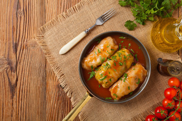 Traditional stuffed cabbage with minced meat and rice, served in a tomato sauce.