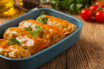 Traditional stuffed cabbage with minced meat and rice, served in a tomato sauce.