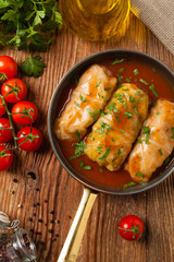 Traditional stuffed cabbage with minced meat and rice, served in a tomato sauce.