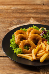 Roasted squid rings with fries.