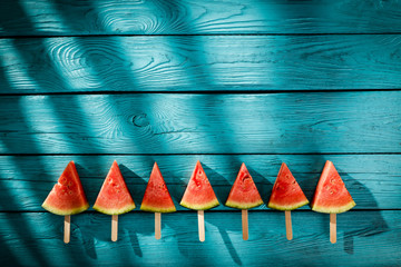 Fresh tasty watermelon on blue wooden board and summer time 