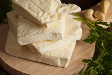 Domestic cows cheese on wood. Macro photography. Tasty food