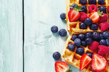 sweet belgian waffles with berries and chocolate cream