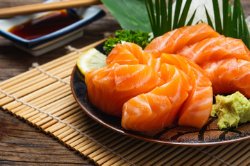 Sushi salmon & tuna sushi shrimp and wasabi on the white plate. on the wood table