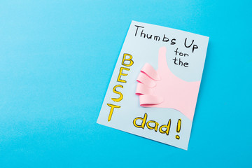 Happy fathers day sign on paper  laid on blue backround.