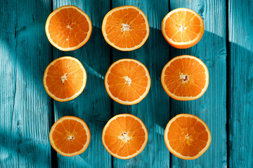 Fresh orange juice on blue wooden board and fresh fruits 