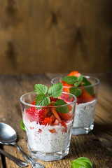 Healthy dessert, coconut milk with chia seeds and fresh strawberries