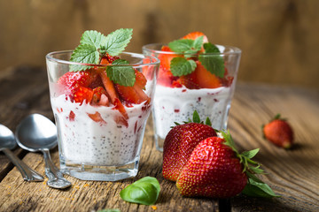Healthy dessert, coconut milk with chia seeds and fresh strawberries