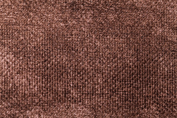 Dark brown background from soft textile material. Fabric with natural texture.