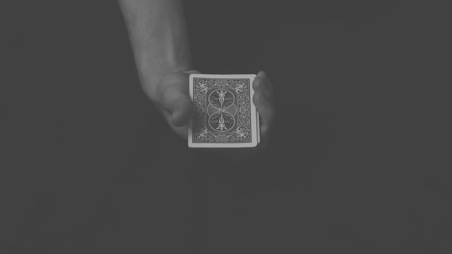 Close-up of a magician performing a simple card trick.