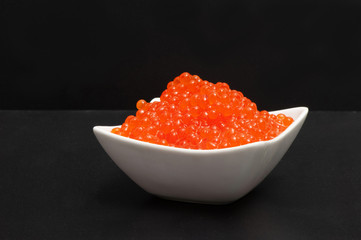Red caviar in a saucer