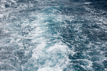 Travel destination motor boat water traces in open caribbean sea.