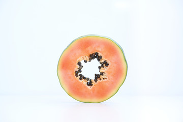 Slice of papaya on white background