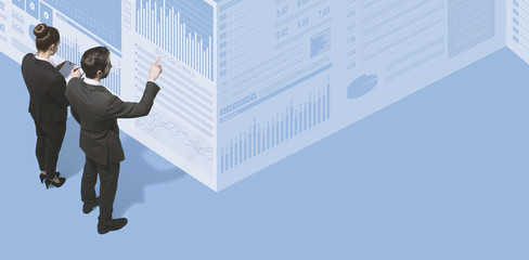 Business people working together and checking financial reports