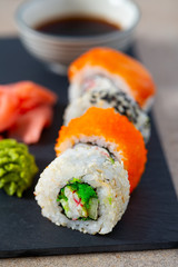 sushi rolls on black stone plate
