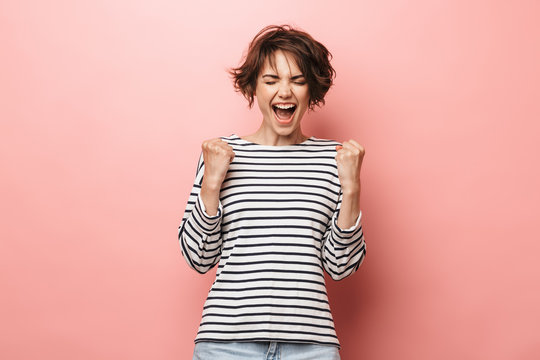 Woman Posing Isolated Over Pink Wall Background Make Winner Gesture.